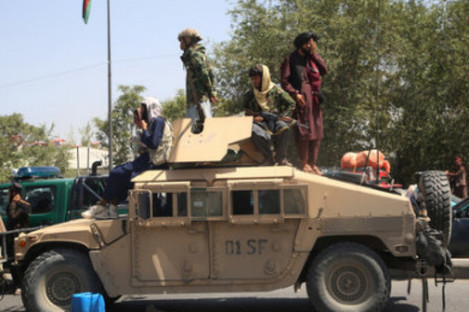 Taliban fighters on a military vehicles in Kabul  last year, when they seized control of Afghanistan