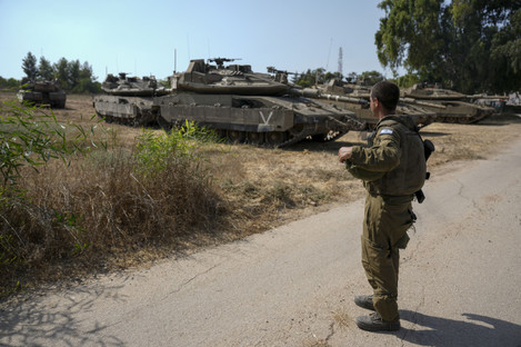 An Israeli soldier secures tanks in an area near the border with Gaza Strip.