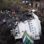 Search for missing bodies after plane crash in Nepal suspended as evening falls