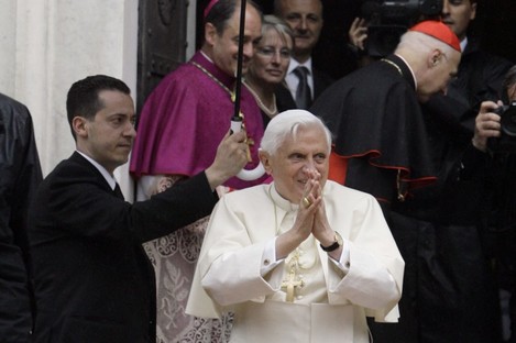 The pope's former butler Paolo Gabriele, at left holding umbrella.