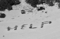 Three men rescued from tiny island in Pacific Ocean after writing 'HELP' on beach using palm leaves