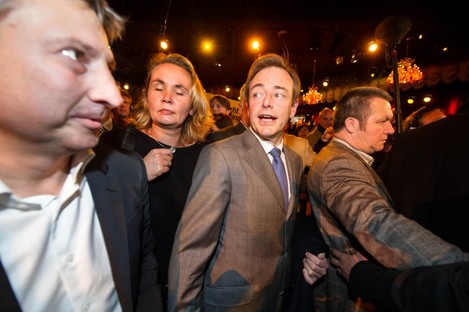 Leader of the NV-A party Bart De Wever, center, arrives at the NV-A election party after they won the city elections in Antwerp, Belgium, on Sunday Oct. 14, 2012.