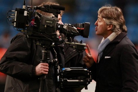 Manchester City manager Roberto Mancini argues with a cameraman last night.