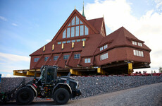 A century-old Swedish church has arrived at its new home - three miles down the road