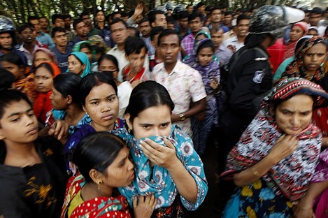 Outside the fire-shattered garment factory in Dhaka, Bangladesh where over 100 people died at the weekend.