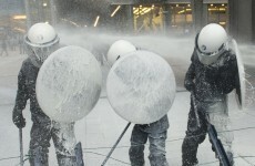 Dairy farmers blast European Parliament and riot police with milk