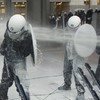 Dairy farmers blast European Parliament and riot police with milk