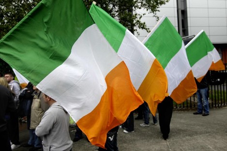 Éirígí supporters hold Irish flags at a protest last year (File photo)