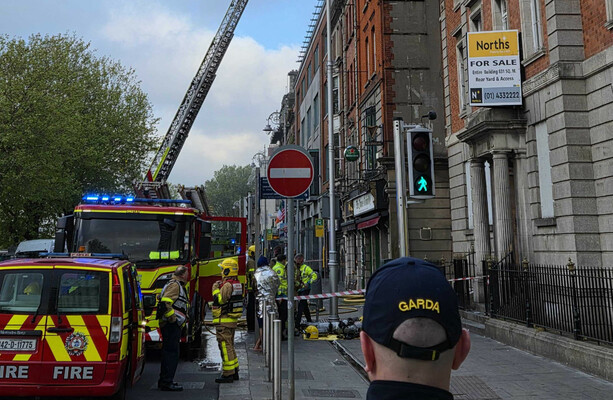 Two hospitalised and Luas services disrupted as fire brigade deal with fire in city centre