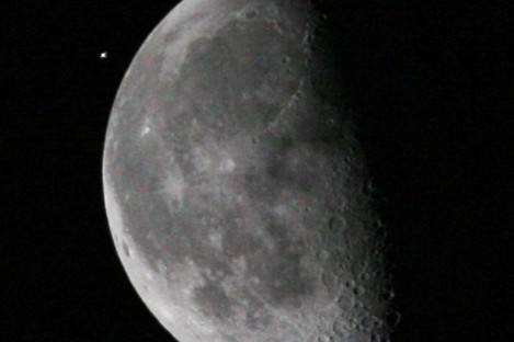 The International Space Station (ISS), upper left, passes the moon as viewed from the Kennedy Space Center, on 5 April, 2010, in Cape Canaveral.