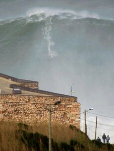 Surfer breaks world record by riding enormous 100-foot wave