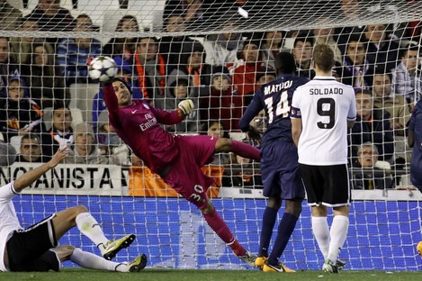 Paris Saint-Germain's goalkeeper Salvatore Sirigu blocks a shot from Valencia during their Champions League round of 16 soccer match.