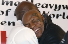 You have to see this photo of Mike Tyson giving Evander Holyfield a giant bear hug
