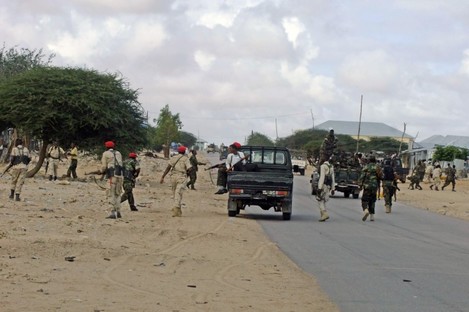Somali government soldiers take position during a clash with suspected Al -Shabab fighters.