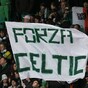 Celtic and Juve fans exchange scarves on the terraces in Turin