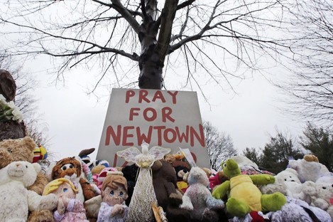 Stuffed animals and a sign calling for prayer sit at the base of a tree near the Newtown VIllage Cemetery in Newtown, Connecticut, after 26 people were shot to death at Sandy Hook Elementary School (file photo).