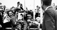 We found the boy smiling up at JFK during his visit to Ireland in 1963