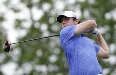 Haas clings to lead, McIlroy makes the cut