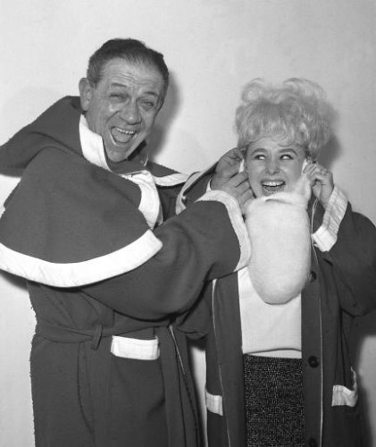 Sid James and Barbara Windsor dress up as Santa Claus for the Variety Club luncheon