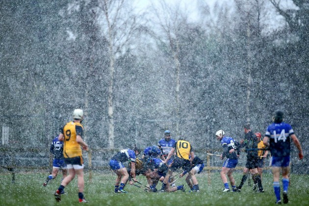 General view of the game between as snow comes down