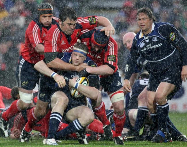Alan Quinlan, Tony Buckley and Anthony Foley tackle Jamie Heaslip