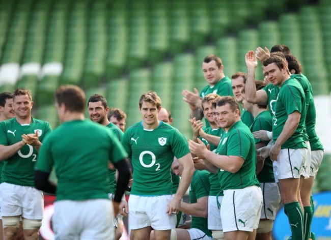 Brian O'Driscoll receives a round of applause from teammates as he arrives late for the team photograph