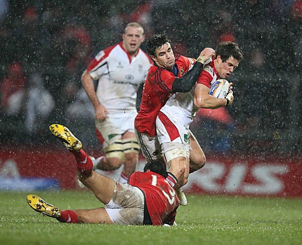 Adam D'Arcy tackled by Casey Laulala and Conor Murray