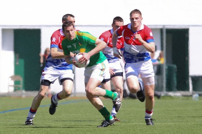 Wayne McKeon carries the ball while being chased by Gary O'Driscoll