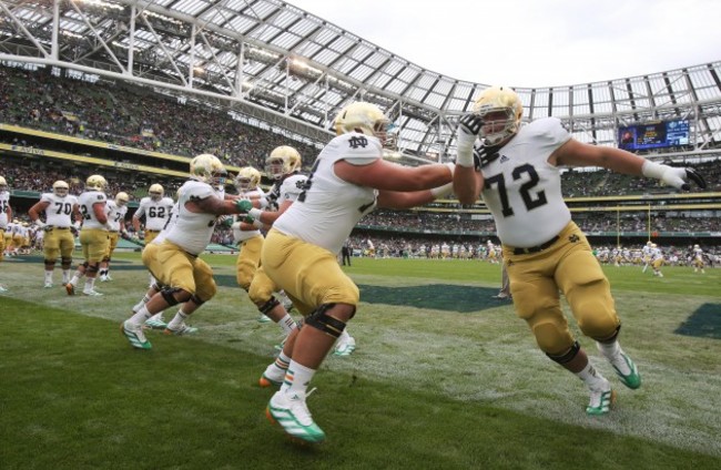 Notre Dame players do warm up drills