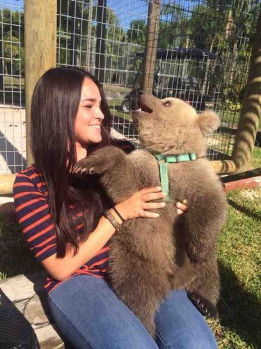 My girlfriend snapped a picture with a baby bear. His reaction is priceless. - Imgur