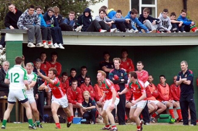 Supporters and the Mayo bench watch the action