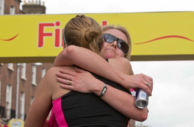 Marie O'Reilly gets a hug at the finish of the Flora Women's Mini Marathon
