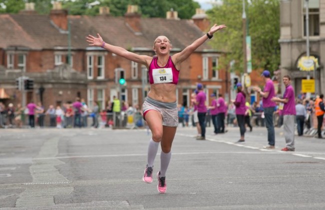 A competitor celebrates crossing the line in the Flora Women's Mini Marathon