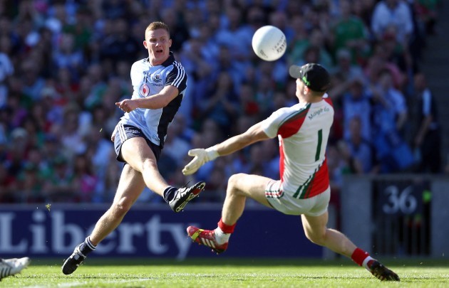 Eoghan O'Gara has a shot saved by Robert Hennelly