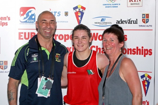 Katie Taylor celebrates winning a gold medal with father Peter and mother Bridget