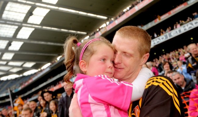 Henry Shefflin hugs his daughter Sadhbh after the game