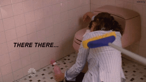 tina-fey-as-liz-lemon-leaning-over-toilet-with-broom-patting-her-back