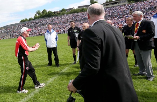 Mickey Harte confronts referee Eddie Kinsella at the end of the game