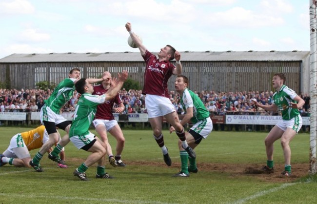 Danny Cummins punches the ball goal ward