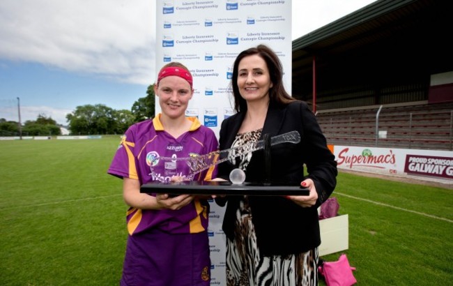 osie Dwyer is presented with the player of the match award by Annette Ni Dhathlaoi