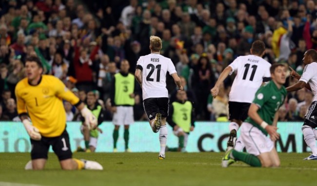 Marco Reus celebrates scoring the first goal as Keiren Westwood and Stephen Ward kneel in dejection