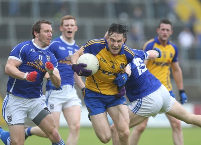 Neil Collins is tackled by Martin Reilly and Michael Lynch