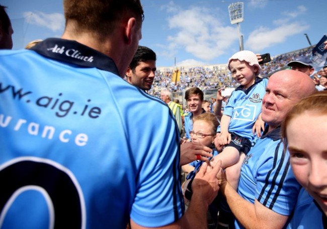 Dublin players bring the trophy to fan Molly McNally after the game