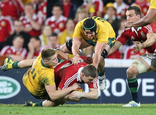 Brian O'Driscoll is tackled by James O'Connor and Liam Gill