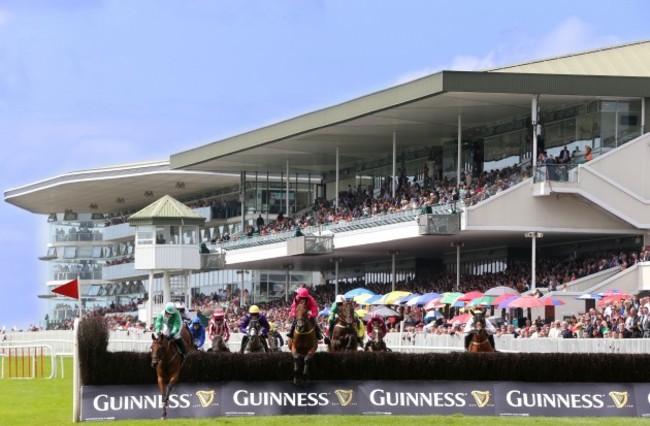 General view of runners and riders clearing a fence