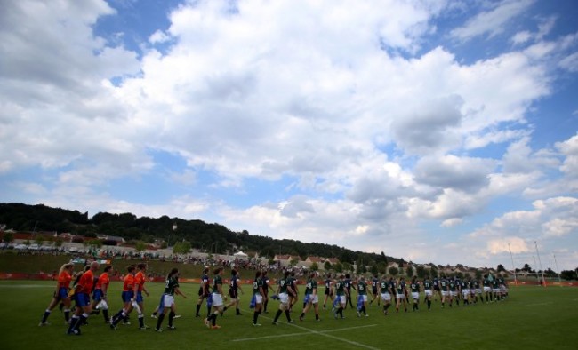 The two teams take to the field before the game