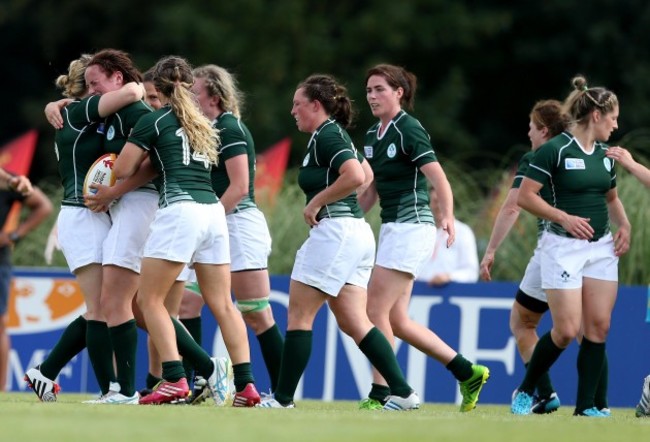 Ailis Egan celebrates scoring a try with teammates