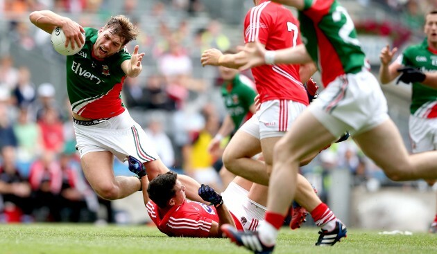 Aidan OÕShea tackled by Tomas Clancy