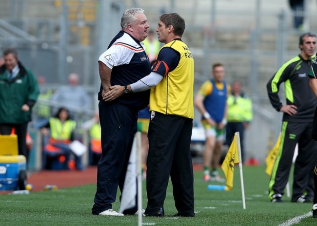 Paul Grimley is held back by Kieran McGeeney