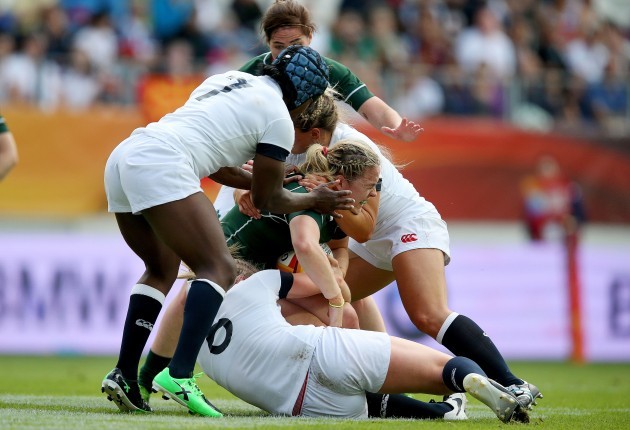 Niamh Briggs tackled by Alex Matthews and Margret Alphons